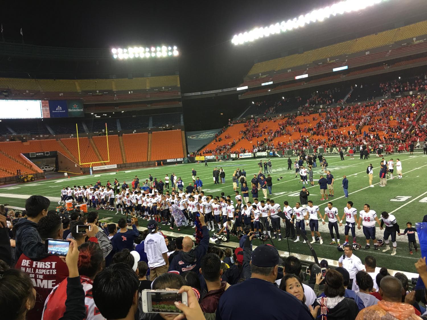 Excited Crusader fans watch as their team sings the alma mater, after defeating Kahuku for the first ever Open Division Championship. Photo by Chord Medeiros