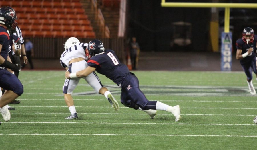 Isaiah Taliulu takes down Kamehamehas running back for a loss.