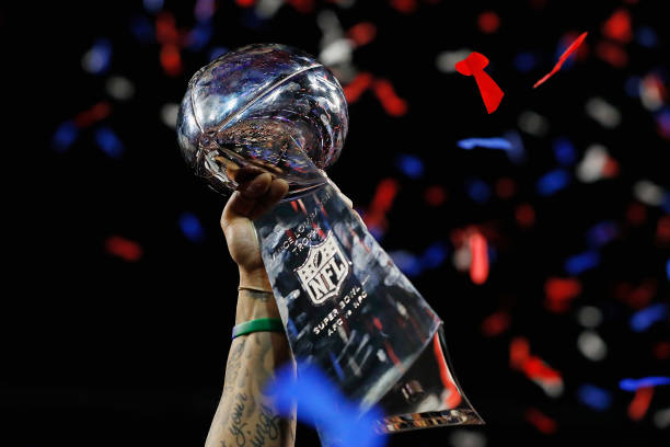 ATLANTA, GA - FEBRUARY 03: A detail of a New England Patriots player raising the Vince Lombardi Trophy after the Patriots defeat the Los Angeles Rams 13-3 during Super Bowl LIII at Mercedes-Benz Stadium on February 3, 2019 in Atlanta, Georgia.  (Photo by Kevin C. Cox/Getty Images)