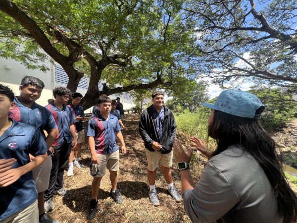 Teacher and SLS Director of Agriculture, John Watase, leads the Indigenous Science class in a recent cleanup of Pālolo Stream.