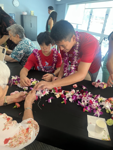 SLS students assist senior residents with lei-making activity.
