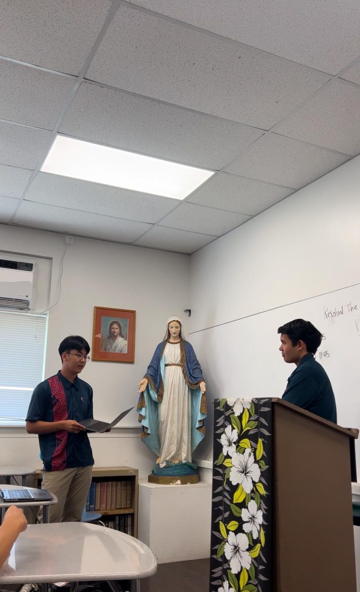 Hamin Seo '24, founder of SLS Economics Club, and senior Kala'e Kong participate in debate in April 2025.