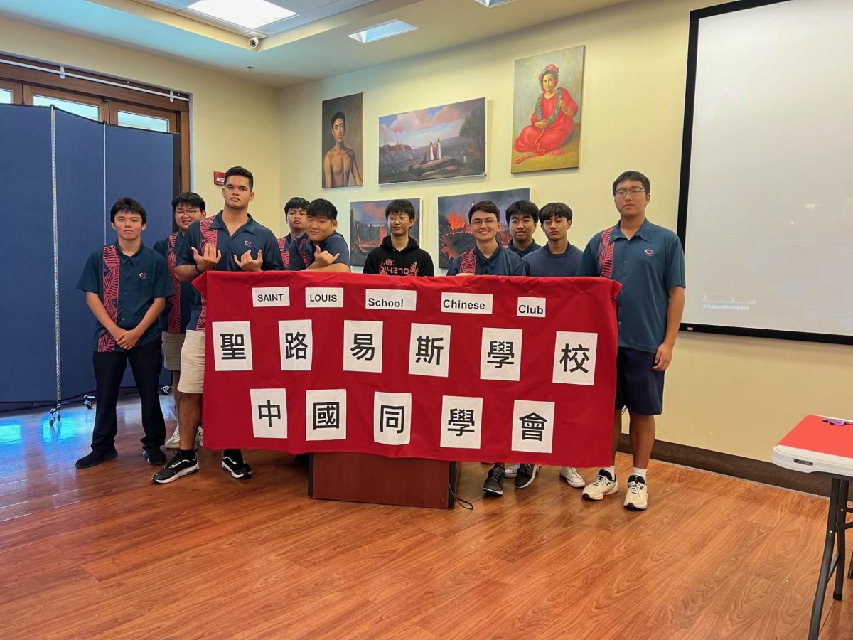 Students pose for a picture behind the banner of the Lunar Festival. 