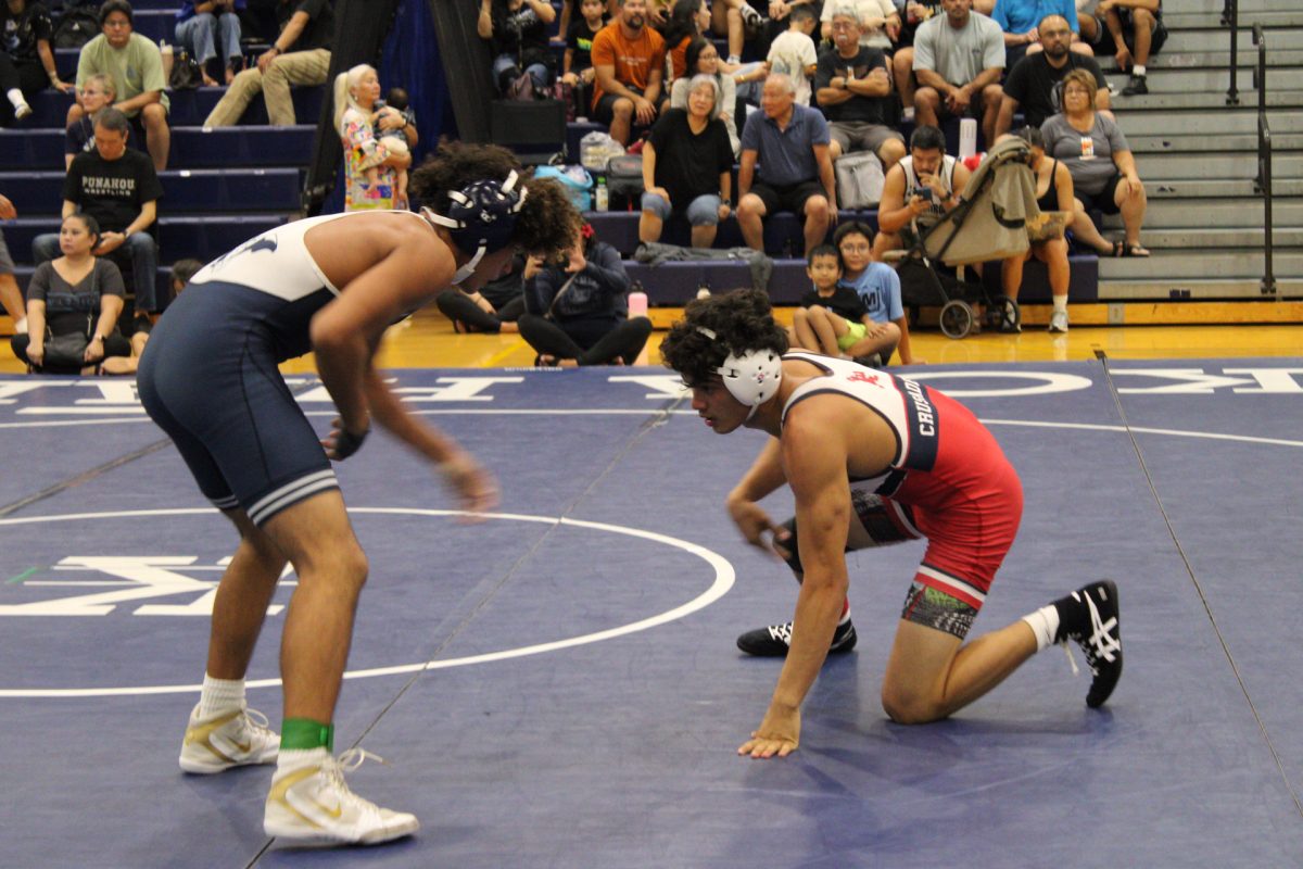 Senior Hunter Berger competing vigorously in his wrestling match.